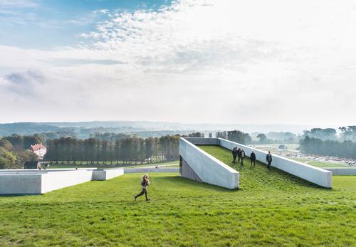 A terrace on the museum's grass roof features a viewpoint of the surrounding orest