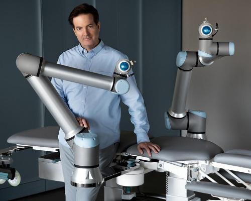 Christian Mackin pictured with Massage Robotics life-sized AI-powered massage robot; Alex