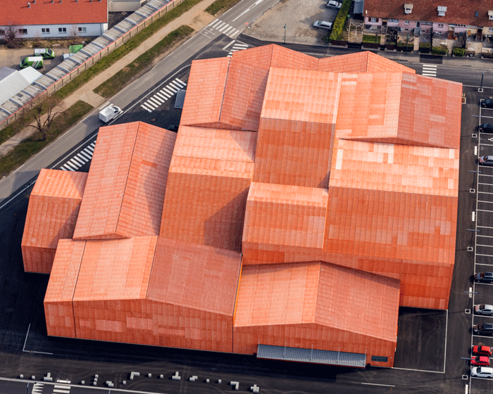 Metal mesh cladding on Basel's new sports and cultural centre gives a unified look