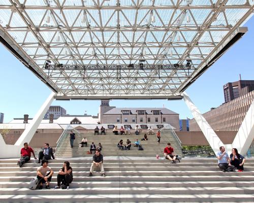 A versatile stage structure under a glazed roof canopy sits at the heart of Nathan Phillips Square in Toronto