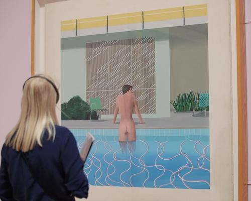 A visitor looks at <i>Peter Getting Out of Nick's Pool</i> during the David Hockney retrospective at Tate Britain in 2017, the second most popular exhibition in Tate’s history

