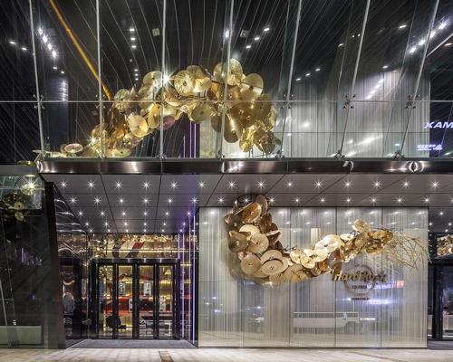 A golden dragon made from drumsticks and 1,680 cymbals dominates the lobby