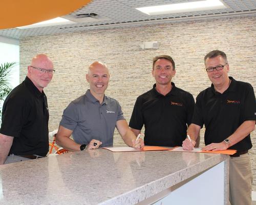 Dave Carney, president Orangetheory (left), with Orangetheory CEO Dave Long (second left) signing the master franchisee deal with Mike Dixon, chair of Wellcomm Health & Fitness (second right) and Alistair Firth, CEO of Wellcomm Health & Fitness (right)
