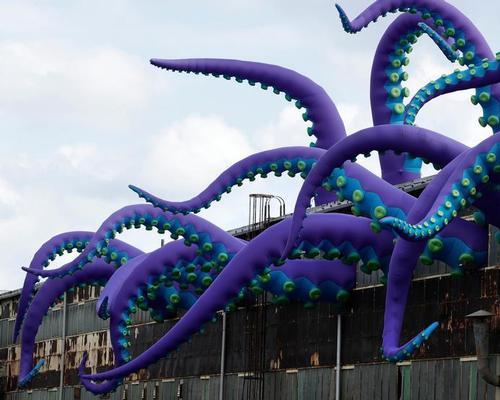 Ranging in size from 32-40ft long, the tentacles twist and curve out of the building and have a series of green suction cups lined along their undersides