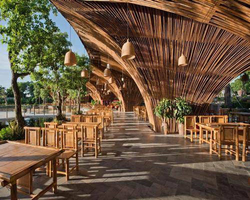 Roc Von restaurant is formed of 12 huge bamboo columns which spread upwards, creating a canopy that covers a semi-outdoor dining area. 
