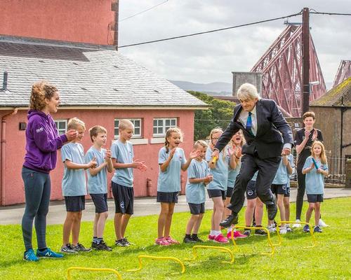 Sportscotland chair Mel Young (jumping) taking part in an Active Schools session