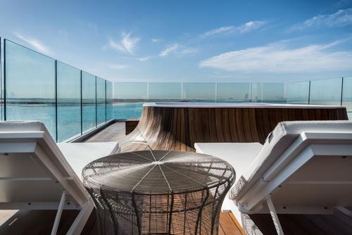 The outdoor deck features a glass-bottomed Jacuzzi / Kleindienst Group