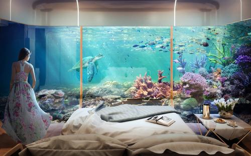Floor-to-ceiling glass windows allowing a clear view of the sea life / Kleindienst Group