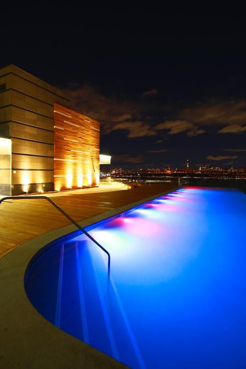 The rooftop infinity pool features sweeping views of the New York skyline