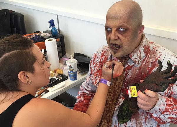 A zombie actor wears a yellow ZTag at ScareLA; and the Gantom torch (inset)