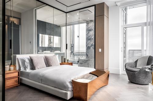 The bedroom features a glass partition that can be switched from transparent to opaque