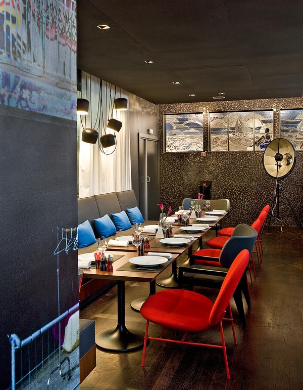 The restaurant and lobby feature raw concrete, exposed ducts and pops of colour