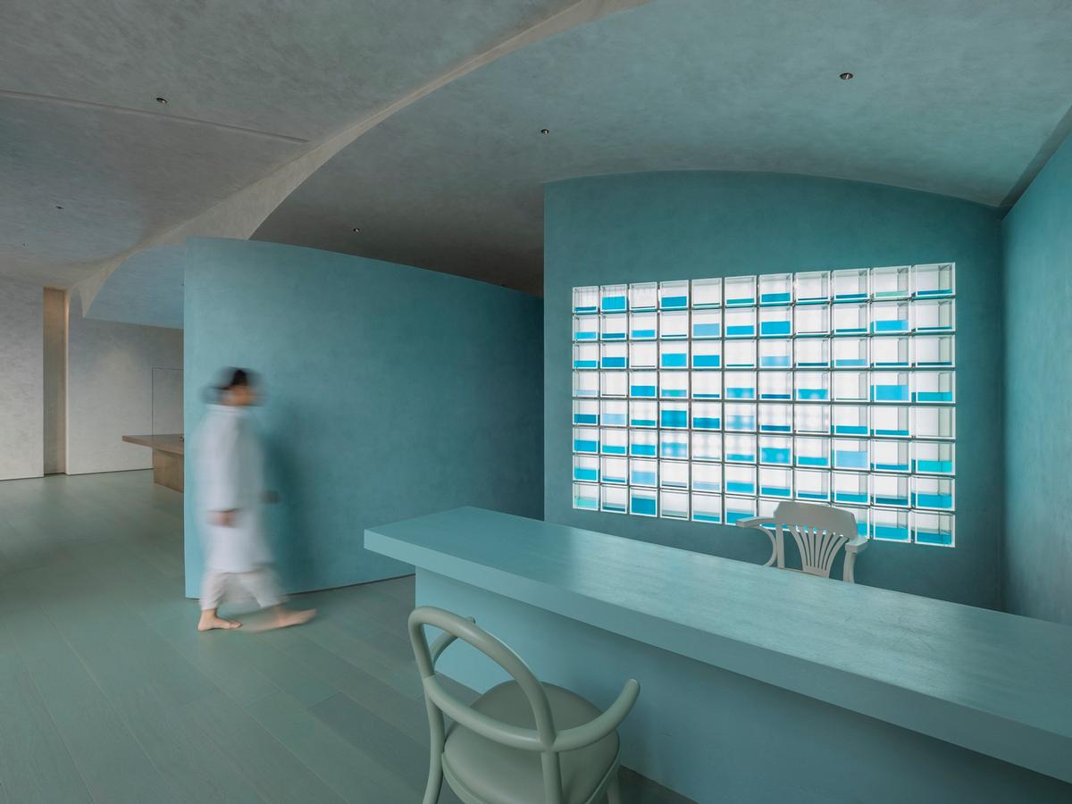 The Chinese medicine counter has a striking aqua design and lighting scheme / Waterfrom Design