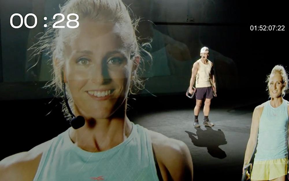 Les Mills used projected image technology, creating a type of hologram effect to show presenters from different countries in the same studio / Les Mills Les Mills used projected image technology, creating a type of hologram effect to show presenters from different countries in the same studio / Les Mills