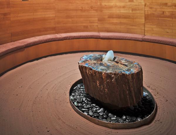 An illuminated quartz on a petrified wood pedestal sits in the centre of the renovated Crystal Grotto / Photo: Douglas Friedman
