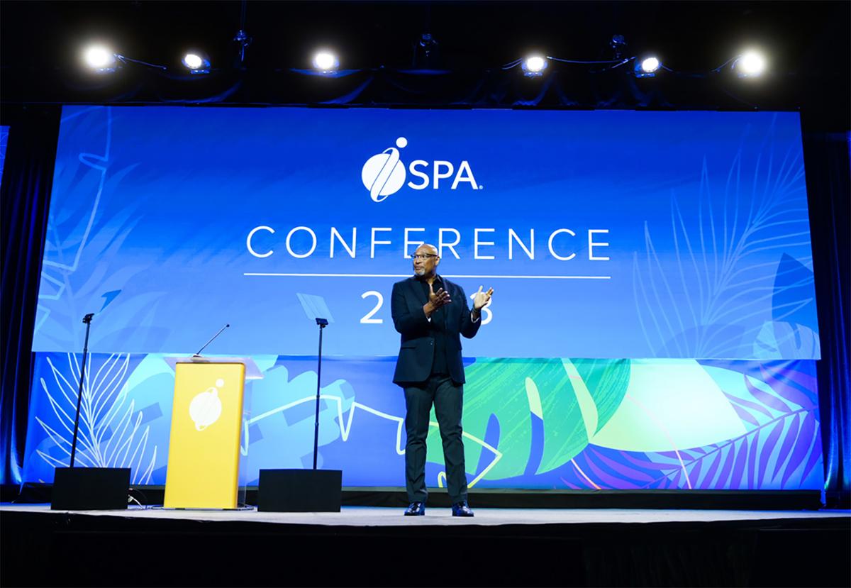 ISPA chair Patrick Huey speaks on the main stage at the ISPA Conference / ISPA 