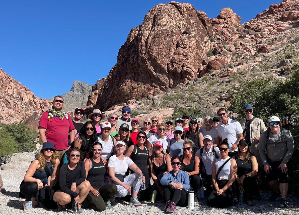In 2023, We Work Well rallied members of the ISPA community together for a charity hike in Red Rock Canyon, Nevada / We Work Well