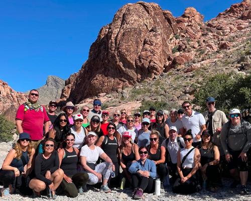 In 2023, We Work Well rallied members of the ISPA community together for a charity hike in Red Rock Canyon, Nevada / We Work Well