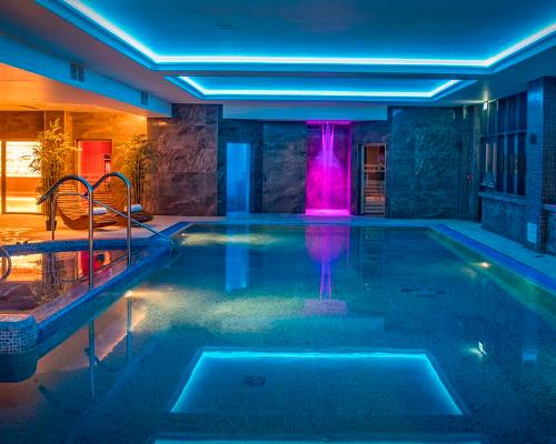 The spa is illuminated with gentle, blue-toned lighting to reflect the spa's waterside location
