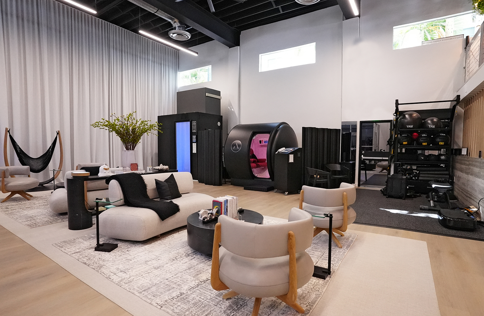 OxyHelp's C2 Chamber in a room with relaxation and exercise areas