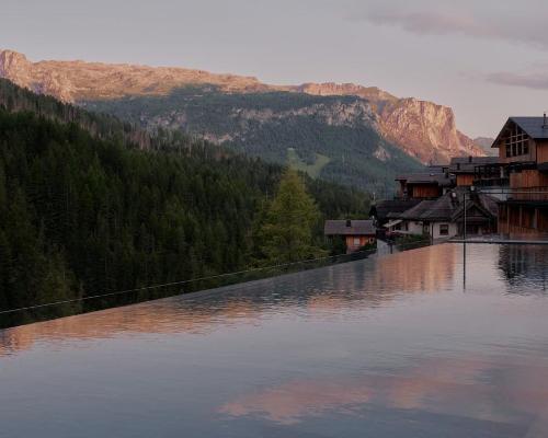 There is a 20-metre heated outdoor infinity pool located on the upper floor of the spa / Aman Rosa Alpina 