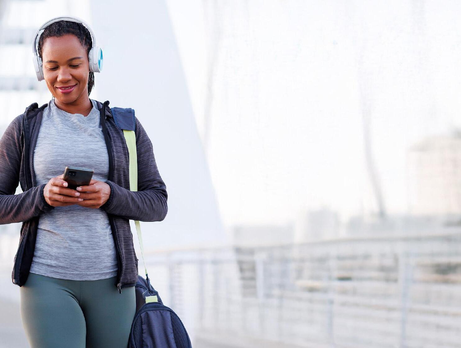 Woman walking whilst looking at phone