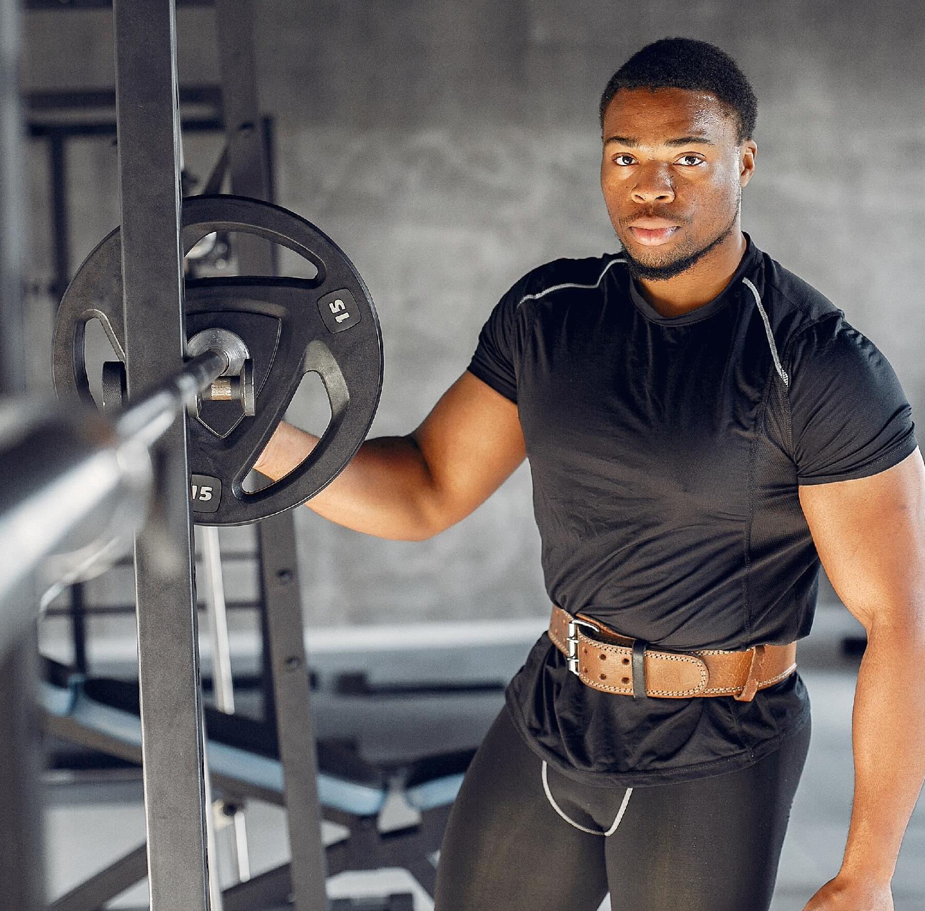 Man standing next to strength equipment