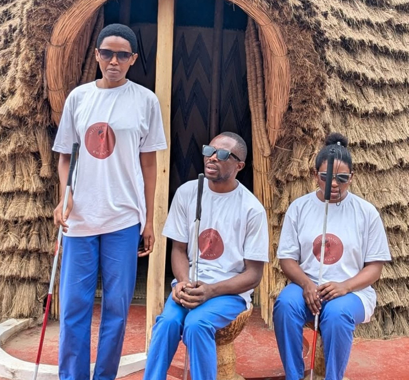 People sitting outside hut