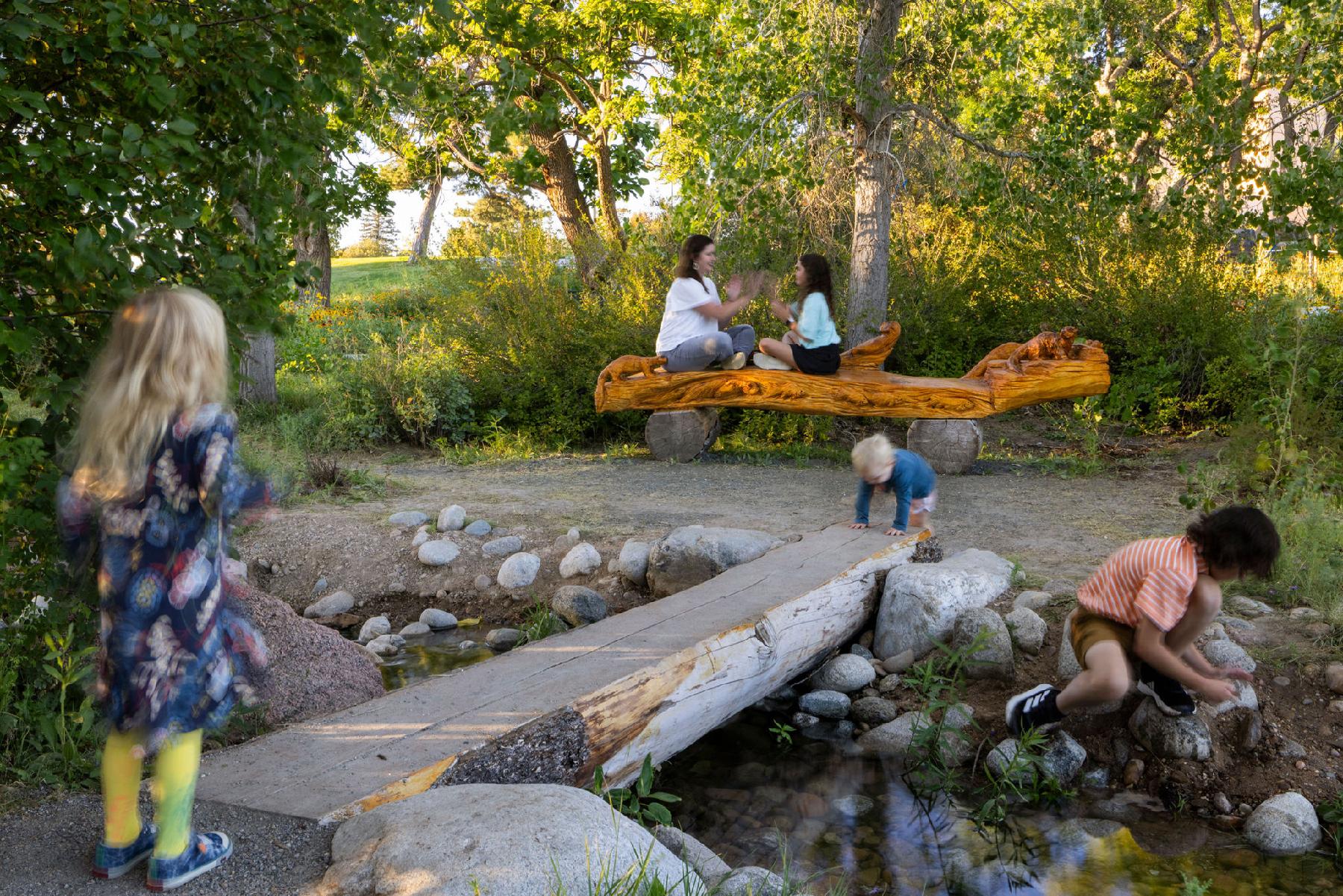 kids in the water feature at the park