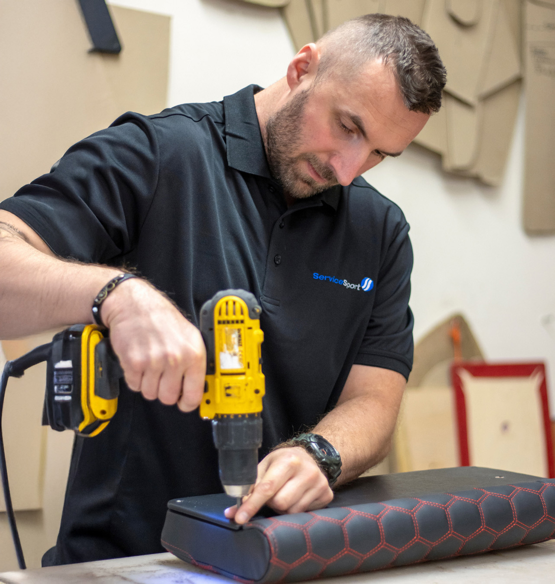 Man from Servicesport fixing gym equipment