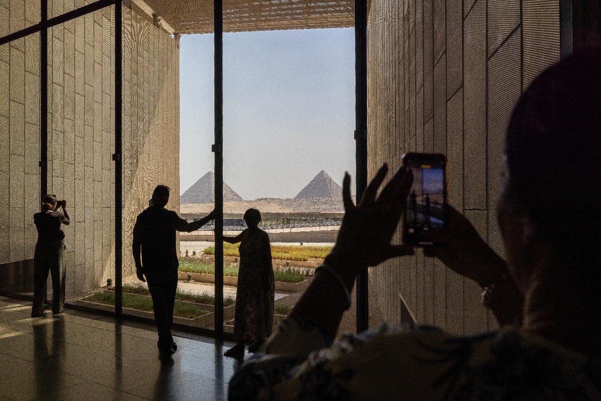 Large windows provide dramatic framed views of the pyramids / Grand Egyptian Museum