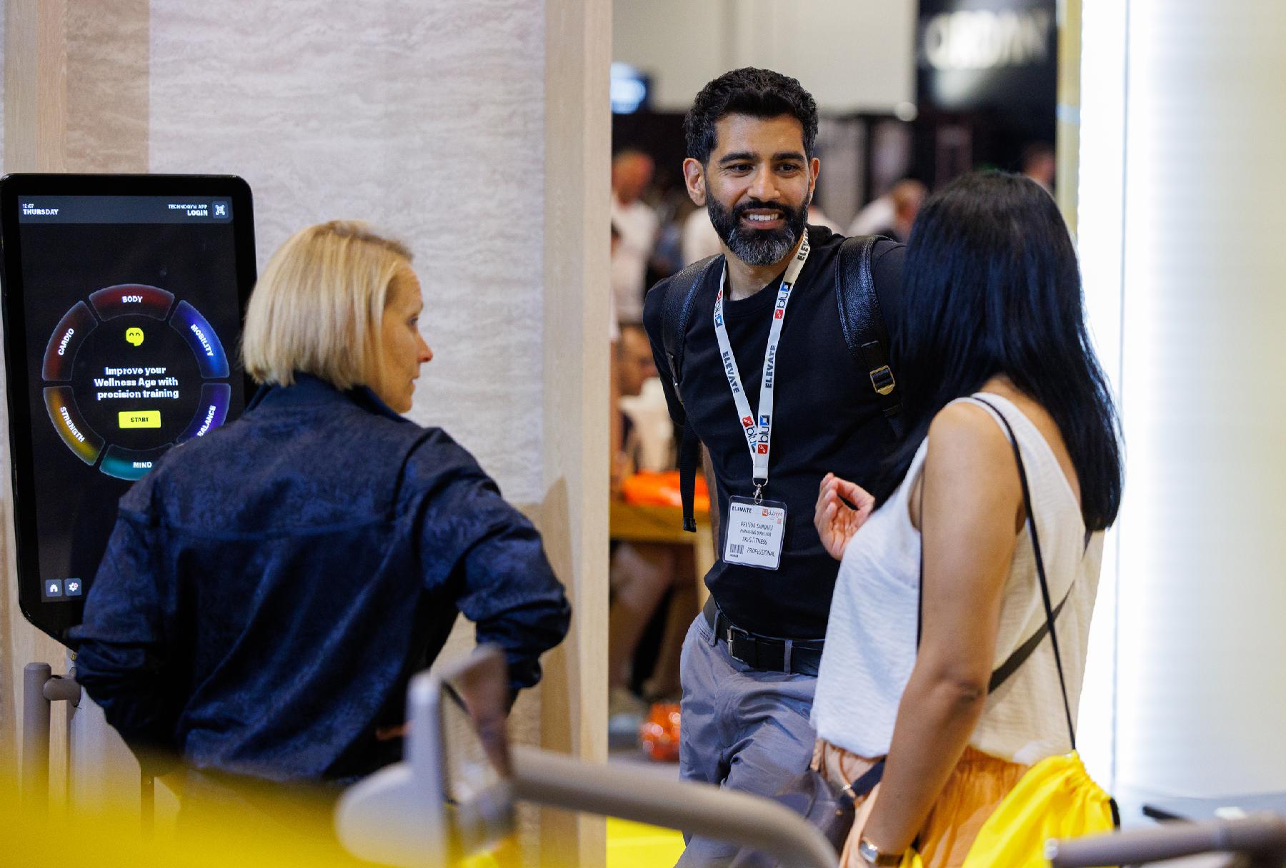 two women and a man chatting at Elevate