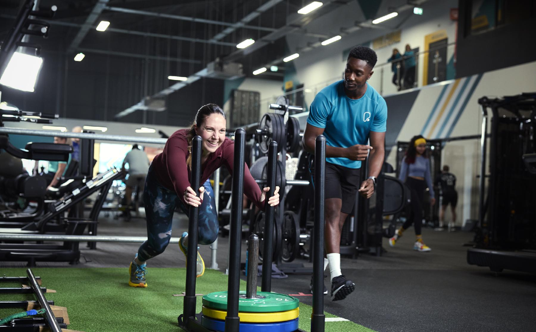 Woman pushing sleigh weights