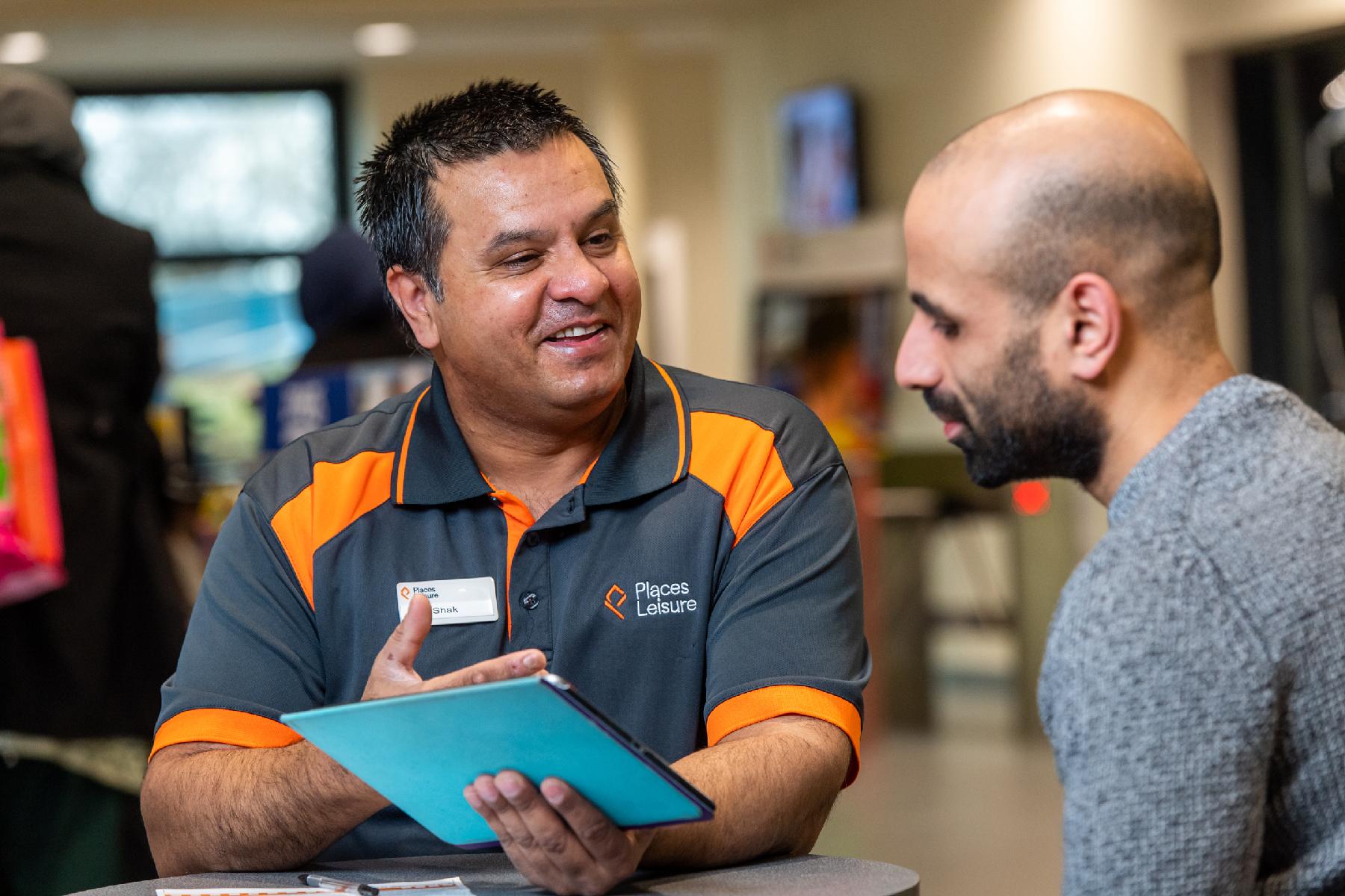 Places Leisure Employee talking to customer