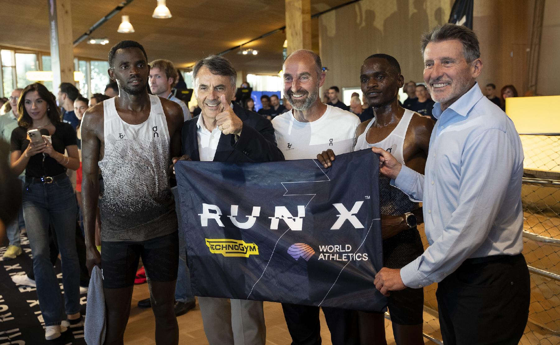 Seb Coe and Nerio Alessandri holding RUN X. banner