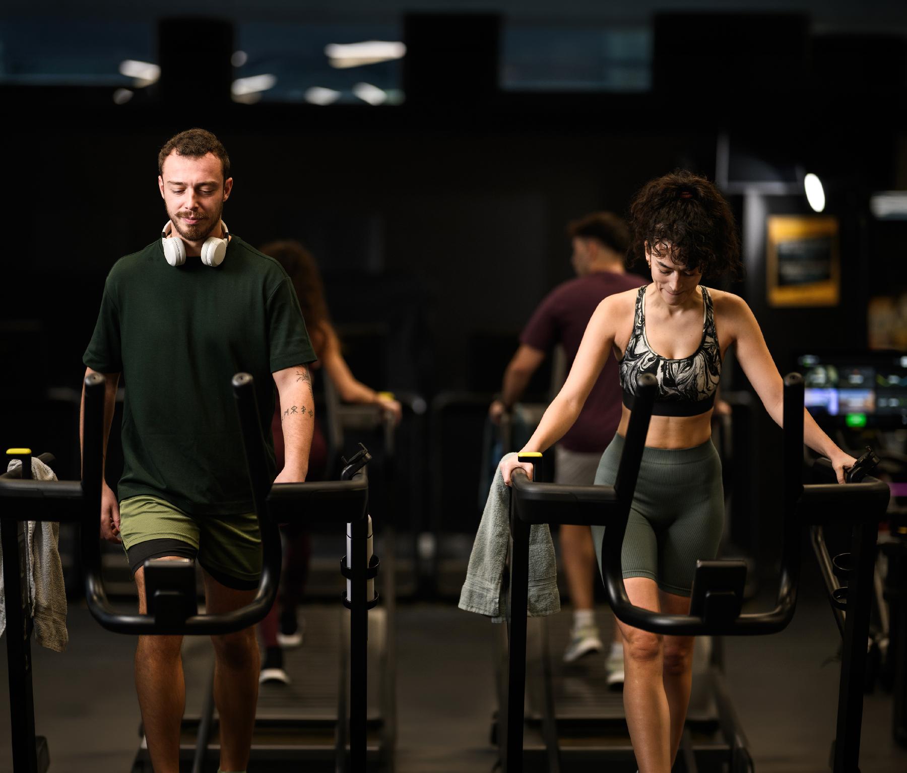 Man and woman using gym equipment