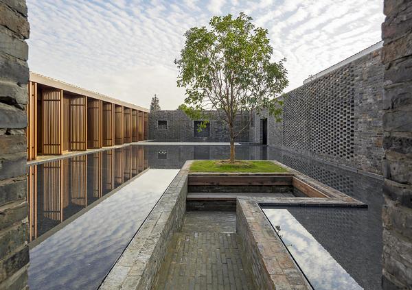 At the Tsingpu Yangzhou Retreat, reclaimed brick walls create multiple courtyard enclosures