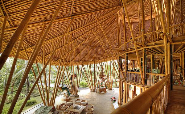 The spiralling Heart of School building forms the centerpiece of the Green School. Children learn in open sided, bamboo classrooms