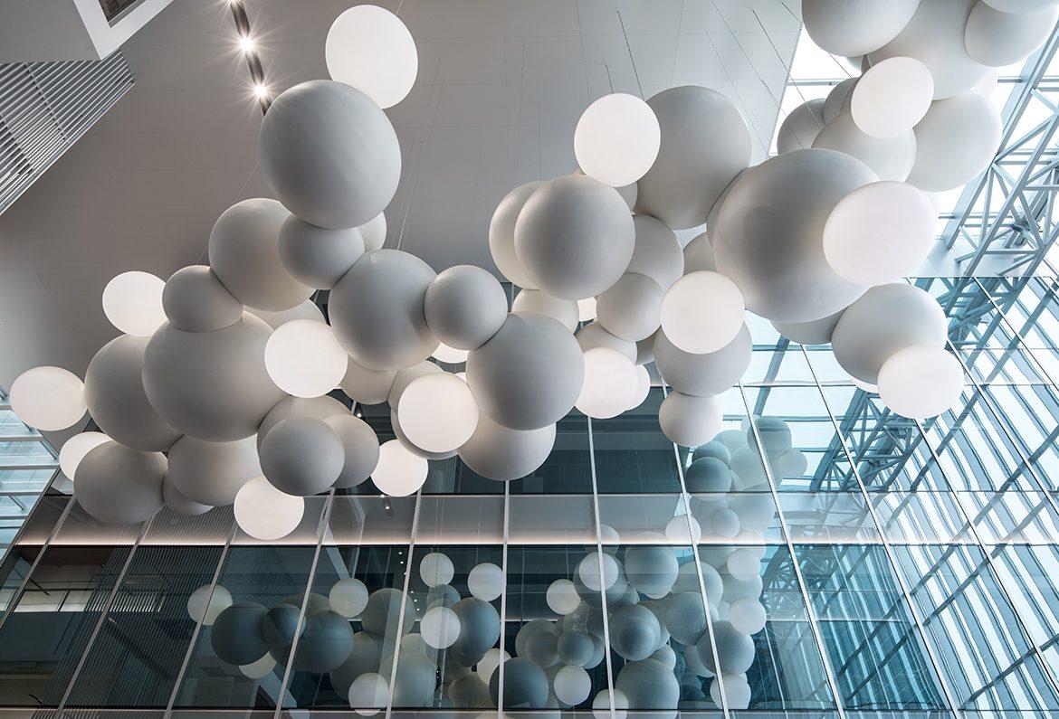 Behind the façade, a suspended sculpture installation by French artist Charles Petillon called 'CloudStorm' dominates the ceiling and above-head space.
/ Yuzhu Zheng