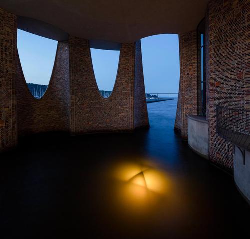 At night the building, which is set with a number of internal lights, resembles a lighthouse. / Photo by Anders Sune Berg