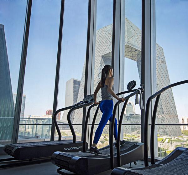 Floor-to-ceiling windows offer panoramic views of the city