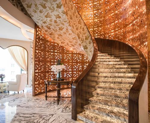  A curved staircase provides a segue from the classical extravagance of the spa reception area to the more contemporary ambiance on the floor above / Reverie Saigon
