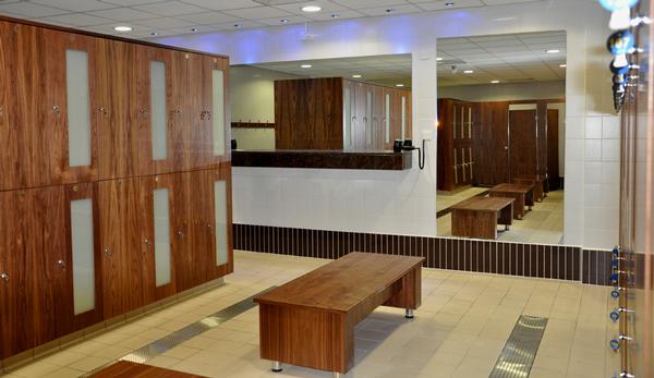 The changing rooms feature walnut veneer lockers with glass panels, and card locks for members