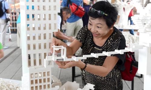 One happy visitor helps create a bridge between two of the architects’ structures / Timothy Schenck