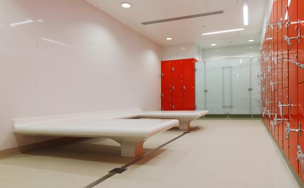 The changing spaces are bright and bold, combining blocks of colour with glazed shower doors