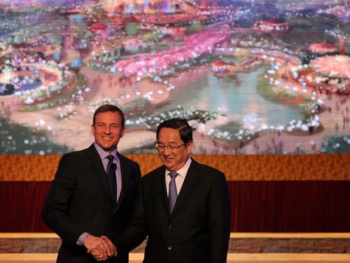 Disney CEO Bob Iger, left, and former Communist Party Secretary of Shanghai Yu Zhengsheng at the official groundbreaking ceremony for Shanghai Disney Resort in 2011 / David Roark/Disney