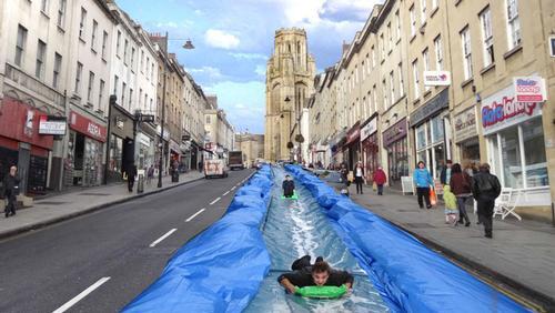 Bristol’s main shopping street was recently transformed into a giant water slide as part of an activity-meets-art initiative