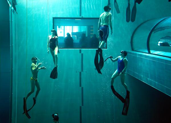Divers enjoy swimming in 4,300 cubic meters of warm spa water in Y-40, the 40m dive tank at the Hotel Terme Millepini, Italy / Photo: OLIVIER MORIN