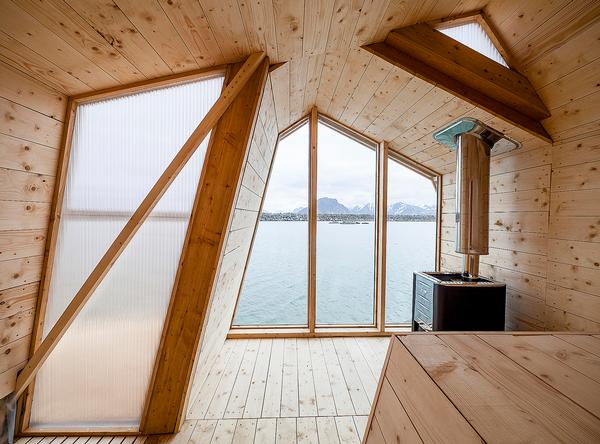 A wood burning stove provides heat for the building. The design is clean and simple, with larch used throughout