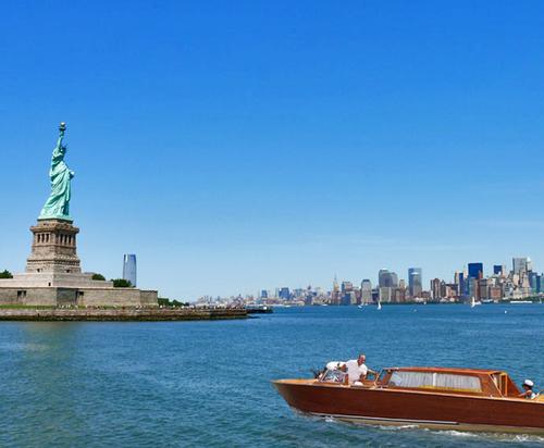 Guests will arrive from Brooklyn or South Manhattan via a wooden Italian water taxi that passes the Statue of Liberty / Bob Henry